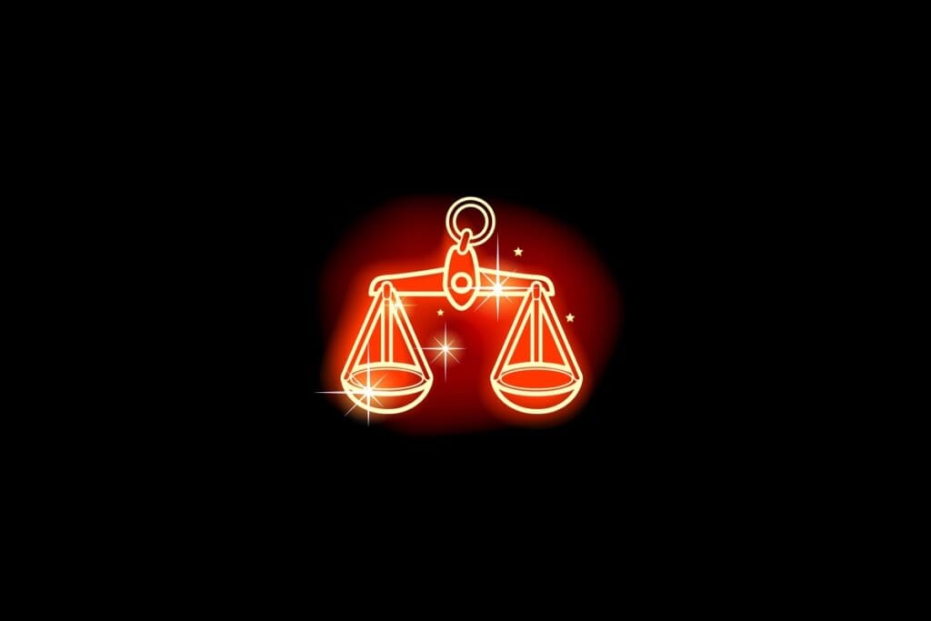 Ilustração em vermelho neon do signo de Libra em fundo preto