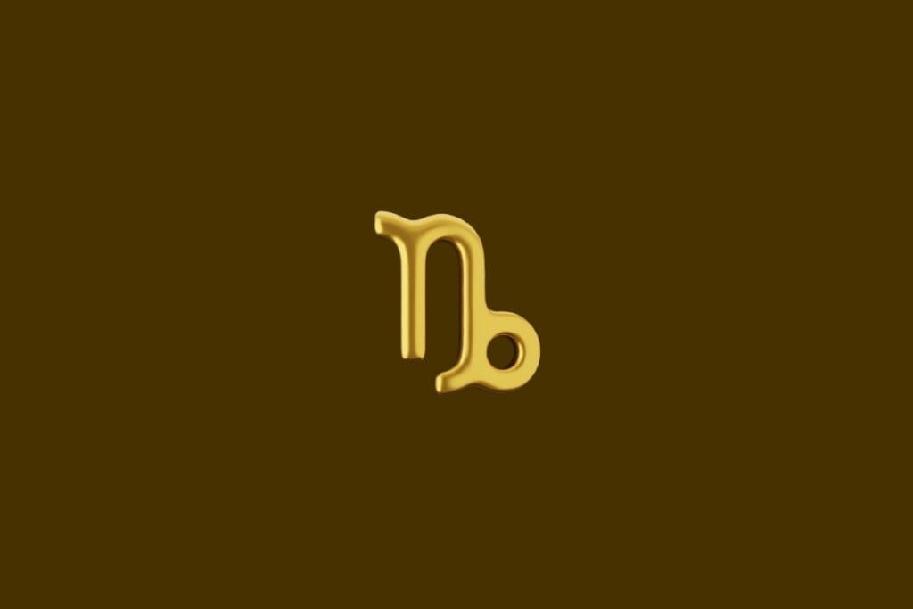 Ilustração do símbolo do signo de Capricórnio dourado em um fundo marrom