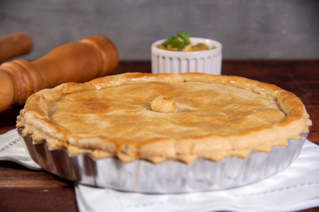 Torta de frango com massa folhada em uma travessa de metal 