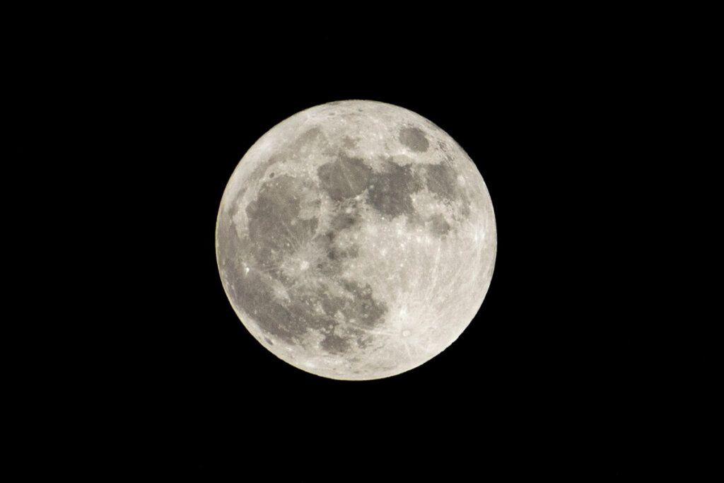Imagem da lua cheia e cinza em céu preto