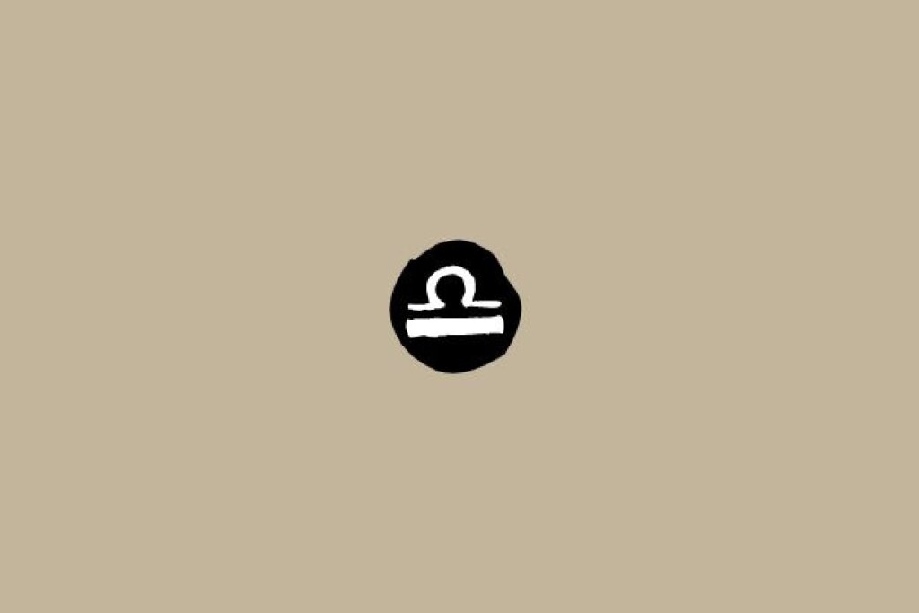 Símbolo do signo de Libra em branco dentro de um círculo preto sobre um fundo bege