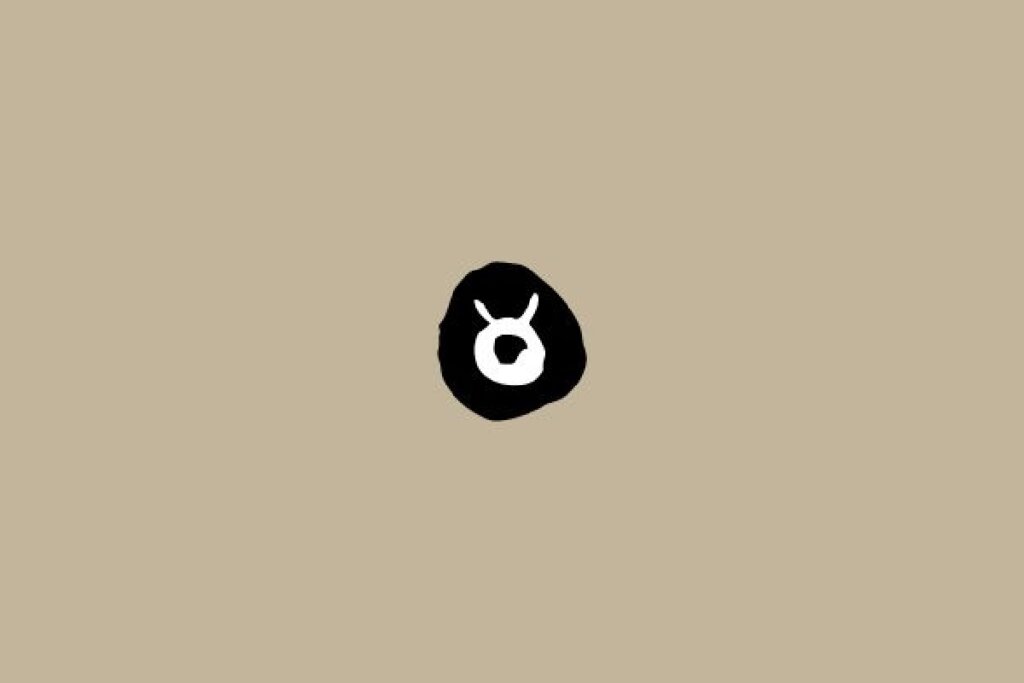 Símbolo do signo de Touro em branco dentro de um círculo preto sobre um fundo bege