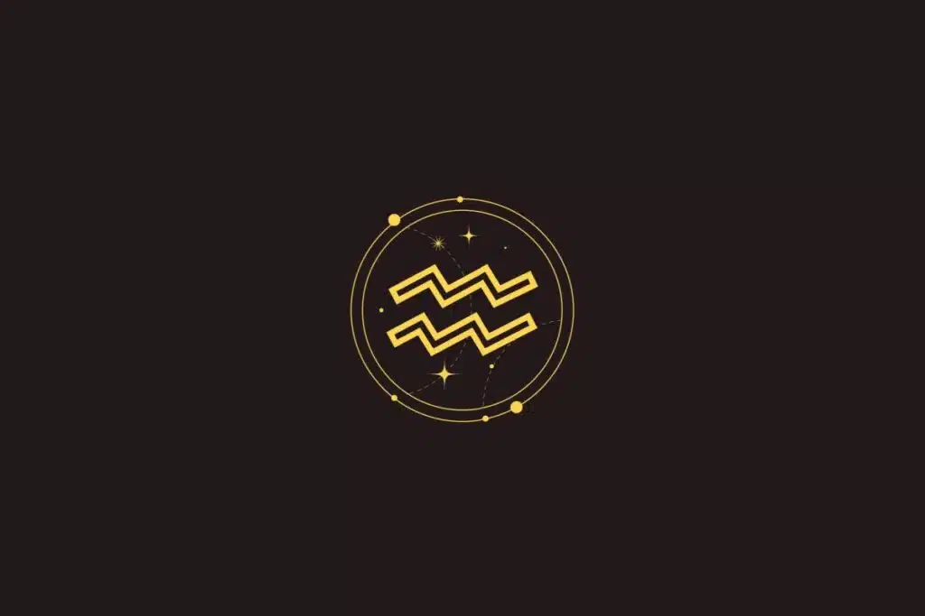Ícone dourado do signo de Aquário com linhas onduladas, cercado por um círculo com detalhes de estrelas sobre fundo preto